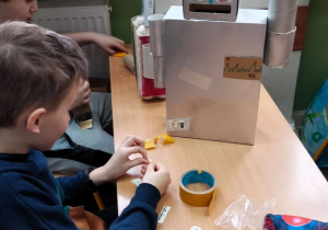Dwóch uczniów w trakcie pracy nad robotem.