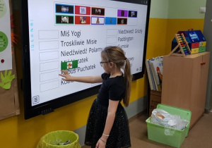 Uczennica wykonuje ćwiczenie na tablicy multimedialnej