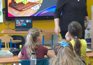 Nauczyciel przed tablicą multimedialną