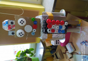 Kolorowy robot z pudeł i plastikowych korków.