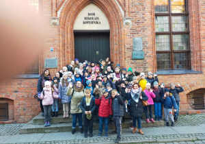 Grupa dzieci przed wejściem do domu Mikołaja Kopernika.
