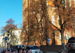 Dzieci zwiedzają Toruń z przewodnikiem.